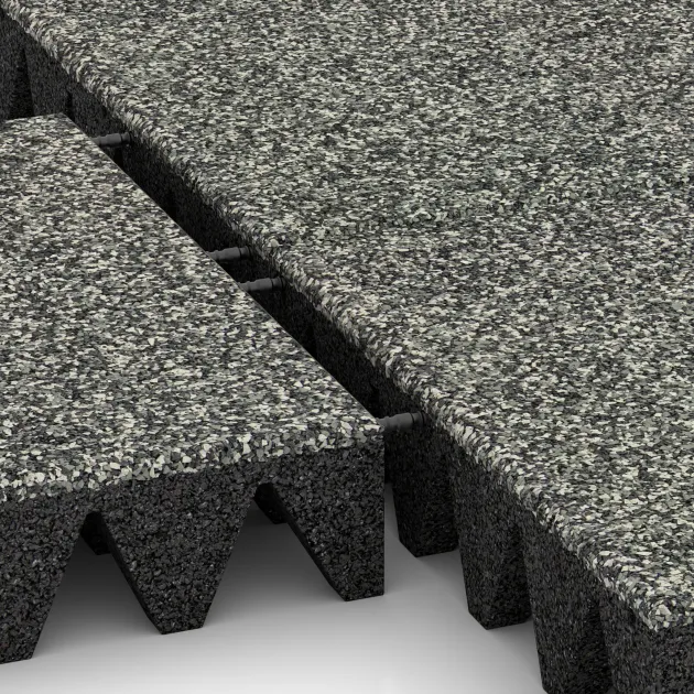 Großaufnahme vom Verbindungssystem von WARCO-Boden 5644 - Mata bezpieczeństwa na plac zabaw 10 cm - EN 1177 ≤ 300 cm im Farbdesign Klasyczny granit. Abmessungen 500 x 500 x 100 mm.